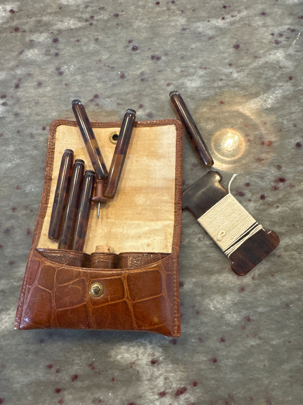 A Vintage Leather Travelling Purse with Backelite Pegs and a Washing Line