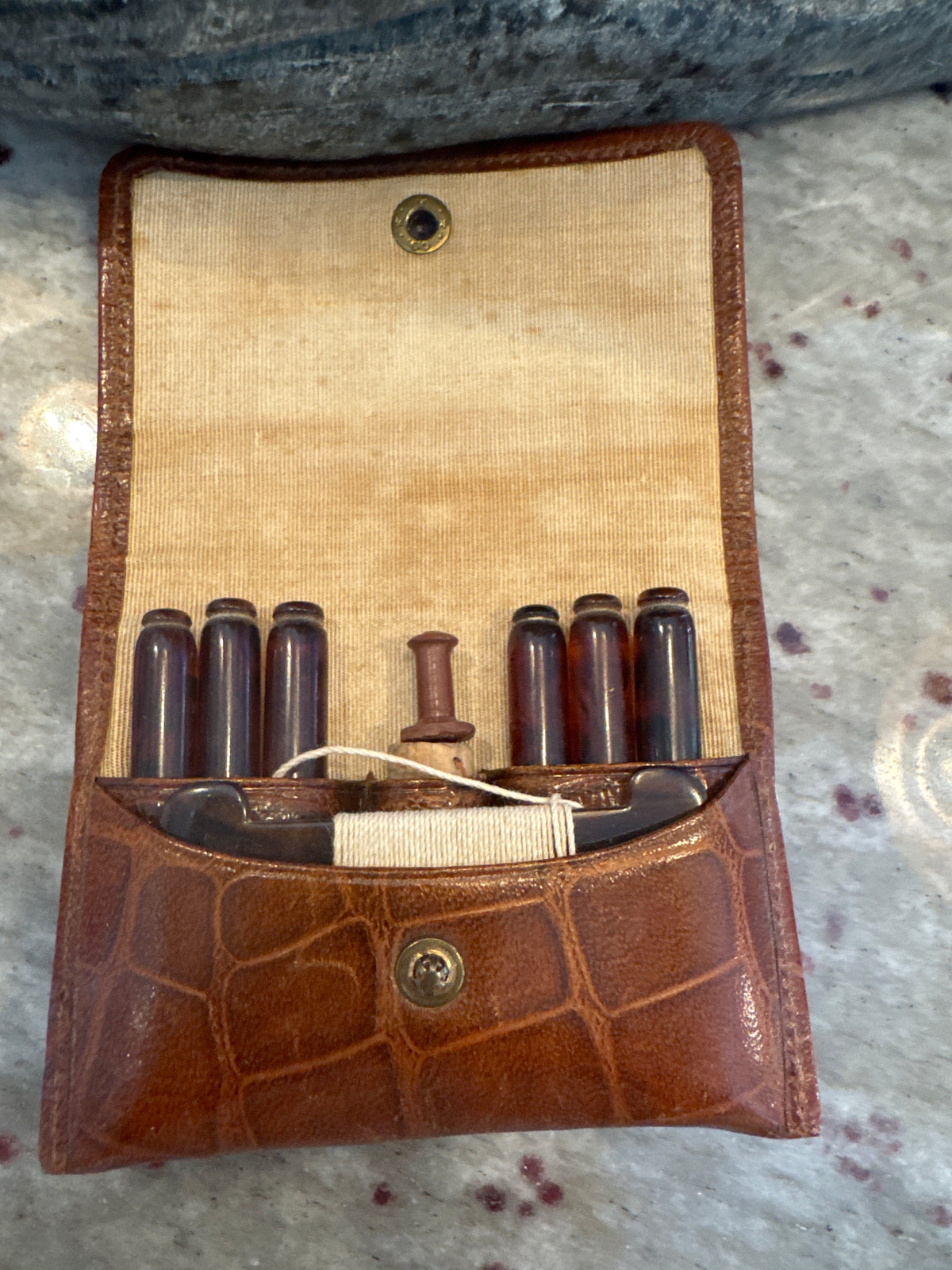 A Vintage Leather Travelling Purse with Backelite Pegs and a Washing Line
