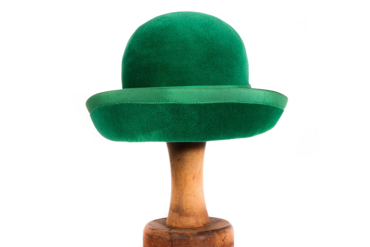 Green hat with ribbon trim 