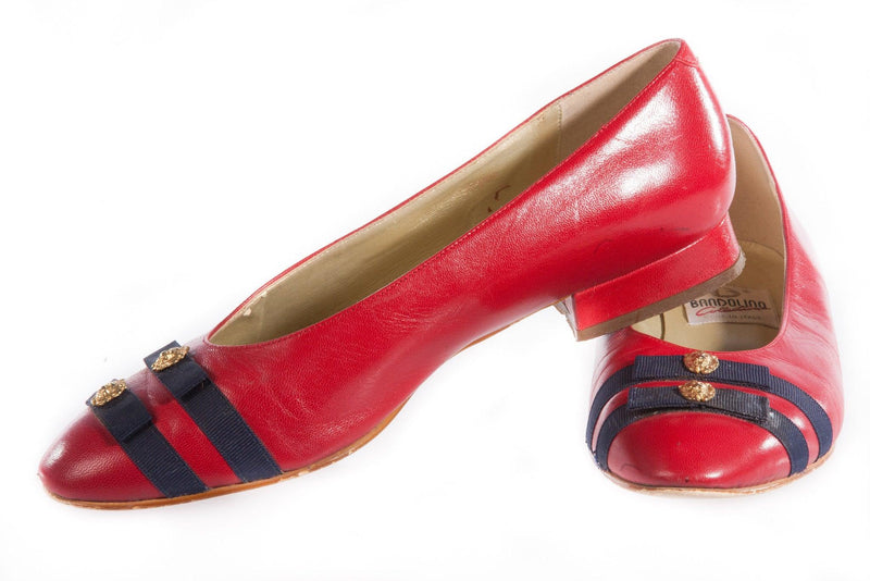 Red patent leather shoes with blue ribbon detail