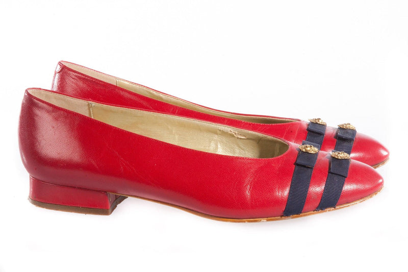 Red patent leather shoes with blue ribbon detail side