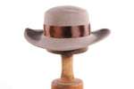 Grey hat with flat back rim and brown bow 