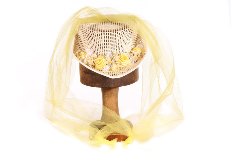 Hat with yellow netting and flowers