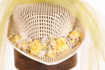 Hat with yellow netting and flowers detail
