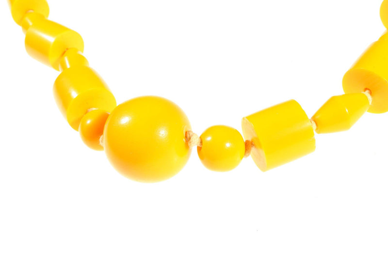 Long yellow beaded necklace detail